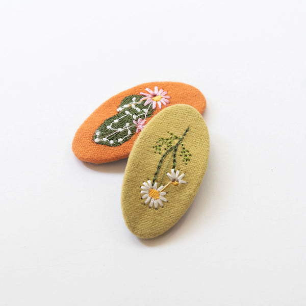 orange and light green oval hair clips with cactus and flower embroidered pattern