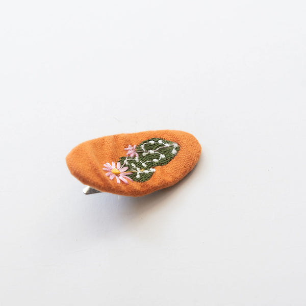 orange oval hair snap clip with cactus embroidered pattern
