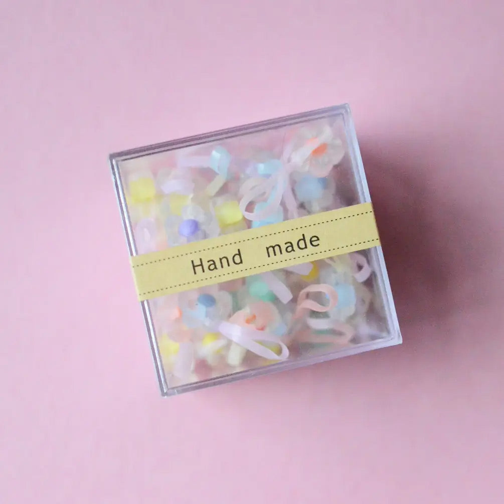 a box of mini flower rubber hair ties