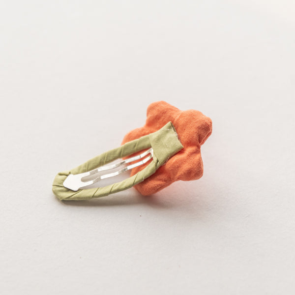 back side of orange flower fabric hair clip