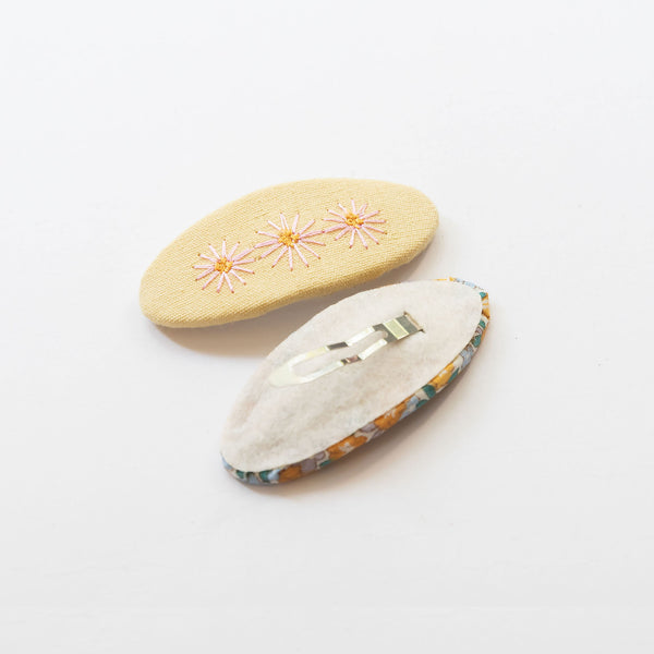 back side of pastel yellow oval hair clips 