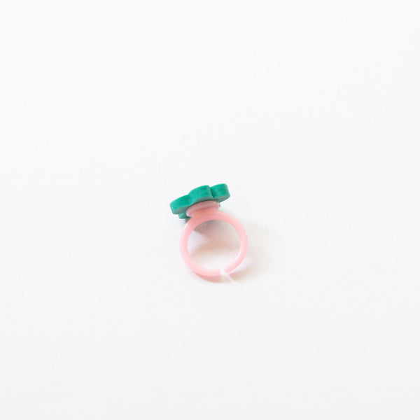plastic ring with a green flower
