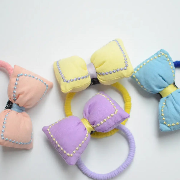 4 colors of bow fabric hair tie: blue, yellow, pink, purple