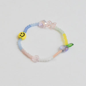 dull colored glass beads with smiley, heart and flower charms elastic bracelet