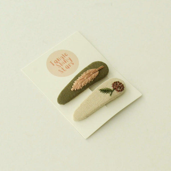 triangular shaped olive and beige hair snap clips with floral embroidered